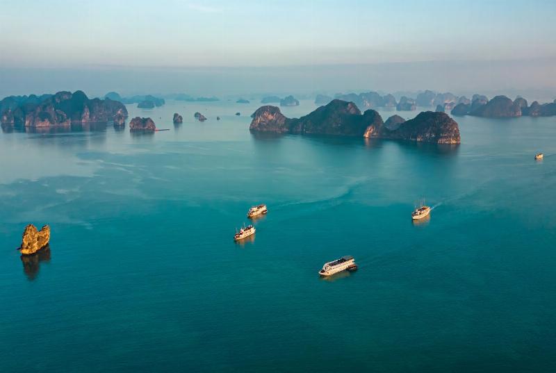 peaceful Do Son beach at sunset with soft sands and pine-covered hills