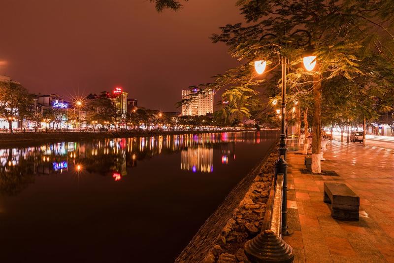 tranquil Tam Bac Lake in Haiphong at evening with reflected city lights